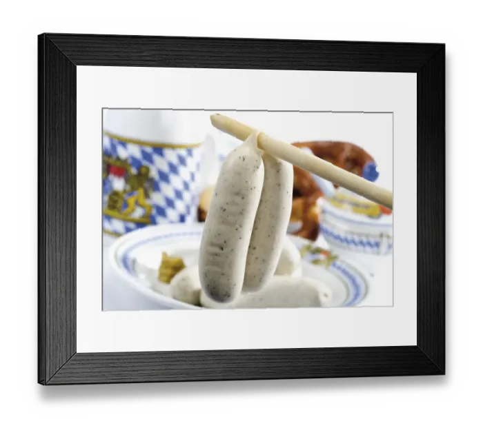 Framed Print : Bavarian veal sausages hanging from a spoon handle