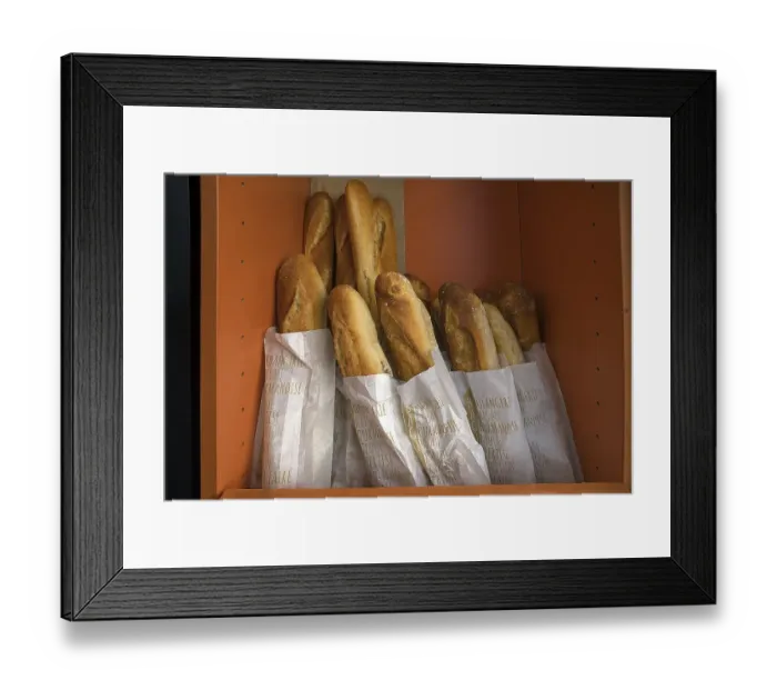 Framed Print : Fresh baguettes in a bread box of a bakery