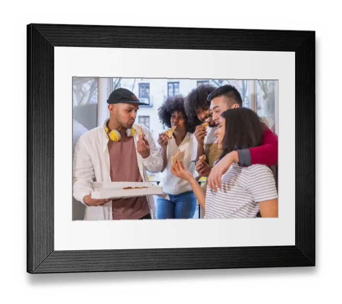 Framed Print : Group of friends eating pizza on the terrace at home