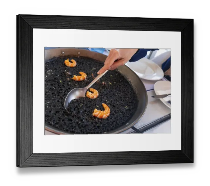 Framed Print : A spoon serving black rice with prawns and squid Framed Print : A spoon serving black rice with prawns and squid