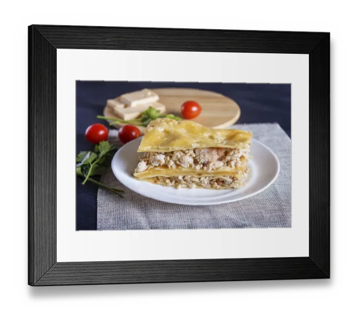 Framed Print : Lasagna with minced meat and cheese on black wooden background
