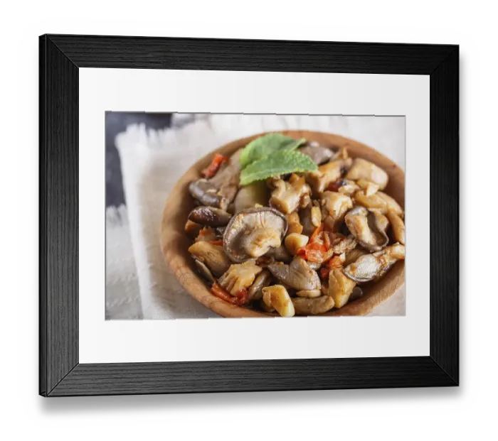 Framed Print : Fried oyster mushrooms with tomatoes in wooden plate on black concrete background Framed Print : Fried oyster mushrooms with tomatoes in wooden plate on black concrete background