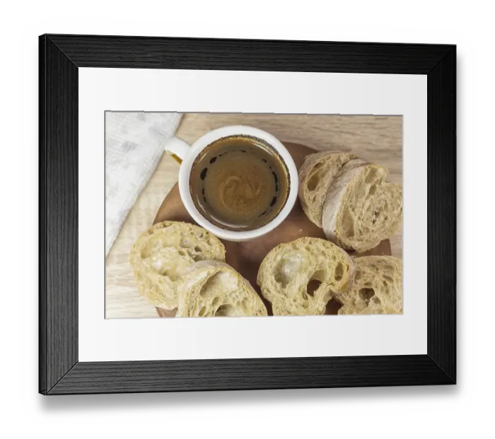 Framed Print : Sliced bread and a cup of coffee on a wooden board and linen tablecloth Framed Print : Sliced bread and a cup of coffee on a wooden board and linen tablecloth