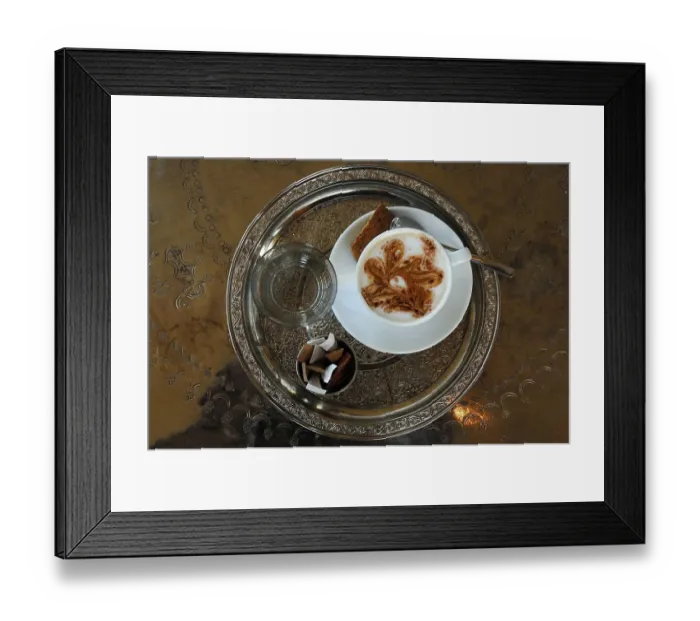 Framed Print : Cup of Cappuccino, glass of water and sugar sachets served on a round silver tablet with engravings Framed Print : Cup of Cappuccino, glass of water and sugar sachets served on a round silver tablet with engravings
