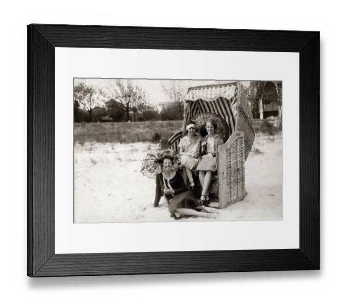 Framed Print : Three women on the beach, two sitting in beach chairs with sunshades