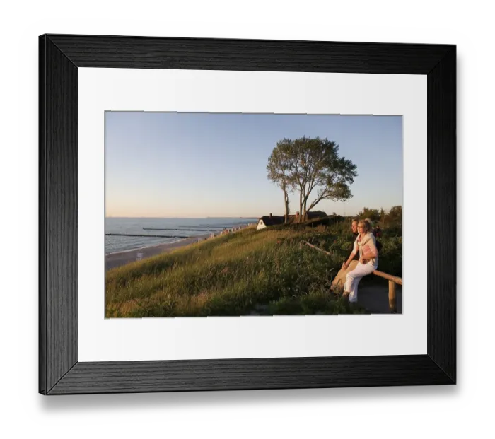 Framed Print : Couple, thatched house at back in the dunes Framed Print : Couple, thatched house at back in the dunes