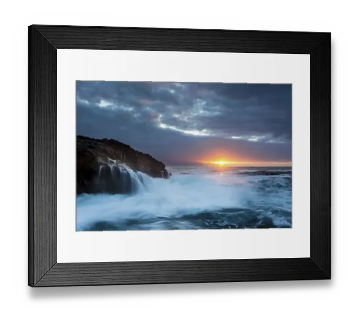 Framed Print : Surf, rocky coast with foaming waves at sunset Framed Print : Surf, rocky coast with foaming waves at sunset