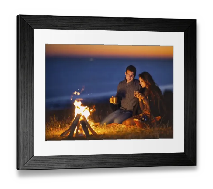 Framed Print : Portrait of the happy couple sitting by fire on autumn beach at the night Framed Print : Portrait of the happy couple sitting by fire on autumn beach at the night