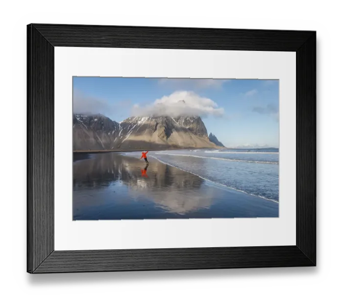 Framed Print : Man runs in a good mood on a black sandy beach Framed Print : Man runs in a good mood on a black sandy beach
