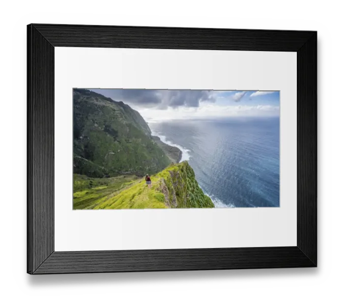Framed Print : Young woman enjoying view of cliffs and sea