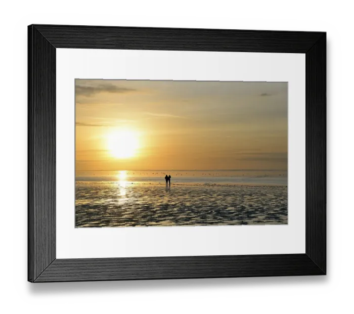 Framed Print : Sunset over the Wadden Sea, two people standing in the mudflats