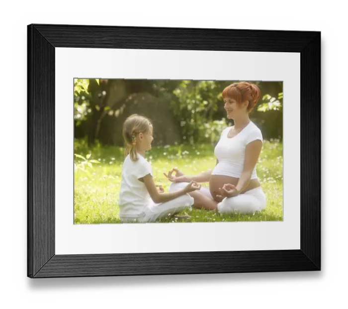 Framed Print : Girl and pregnant woman in yoga position in the garden Framed Print : Girl and pregnant woman in yoga position in the garden