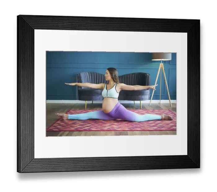 Framed Print : Pregnant sporty woman practicing yoga at home doing stretching exercise the side split pose Hanumanasana Framed Print : Pregnant sporty woman practicing yoga at home doing stretching exercise the side split pose Hanumanasana