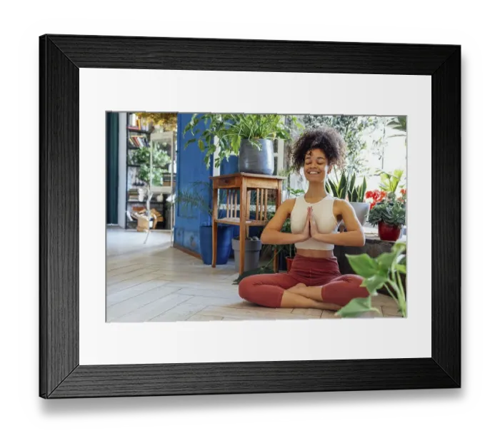 Framed Print : Young adult happy fit slim healthy African American ethnic woman wearing sportswear sitting in yoga pose at home in Framed Print : Young adult happy fit slim healthy African American ethnic woman wearing sportswear sitting in yoga pose at home in