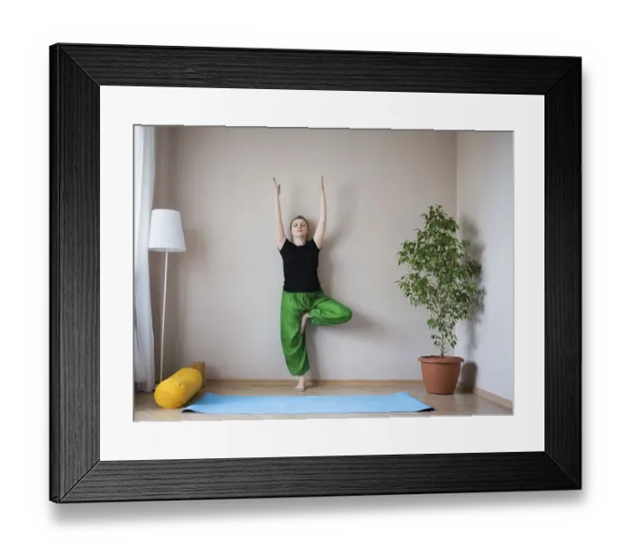 Framed Print : Middle aged or mature woman doing yoga indoors