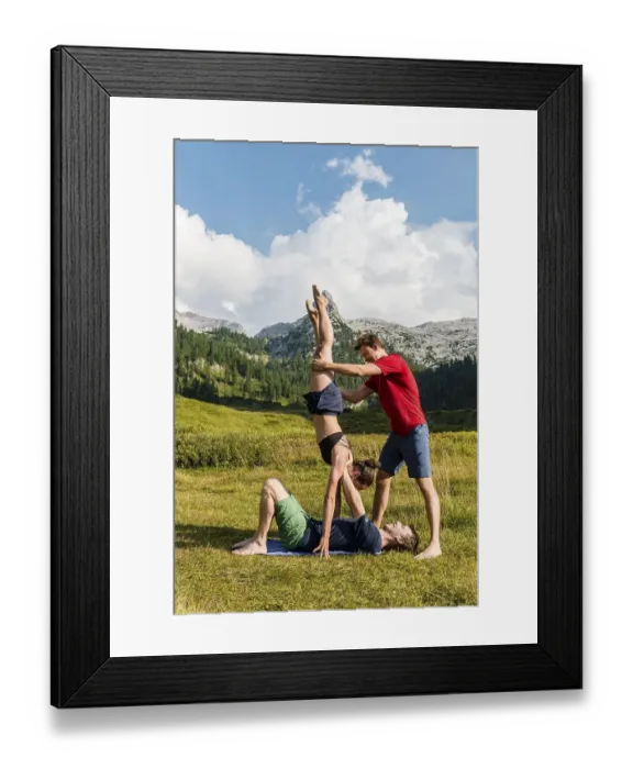 Framed Print : Young woman and young man doing acro yoga
