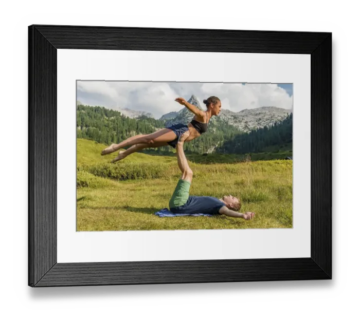 Framed Print : Young woman and young man doing acro yoga Framed Print : Young woman and young man doing acro yoga