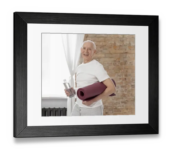 Framed Print : Medium shot senior man holding yoga mat