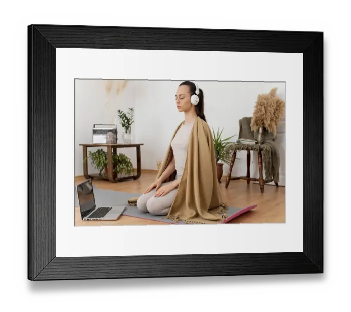 Framed Print : Woman meditating home with headphones