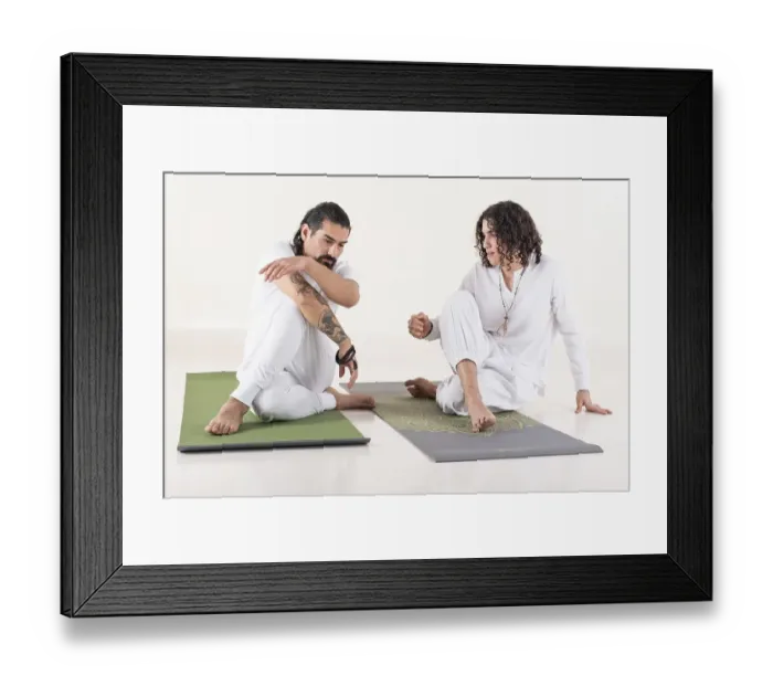 Framed Print : A yoga instructor is teaching yoga to a young man