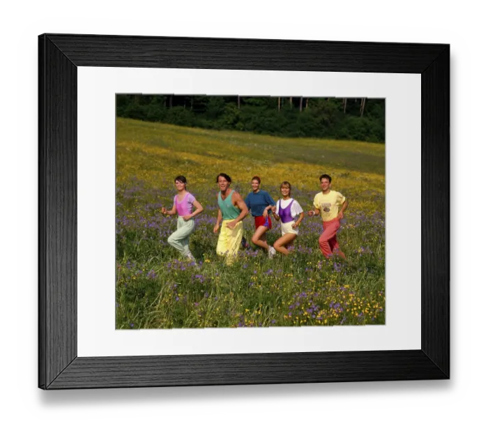 Framed Print : Young people jogging through flower meadow Framed Print : Young people jogging through flower meadow