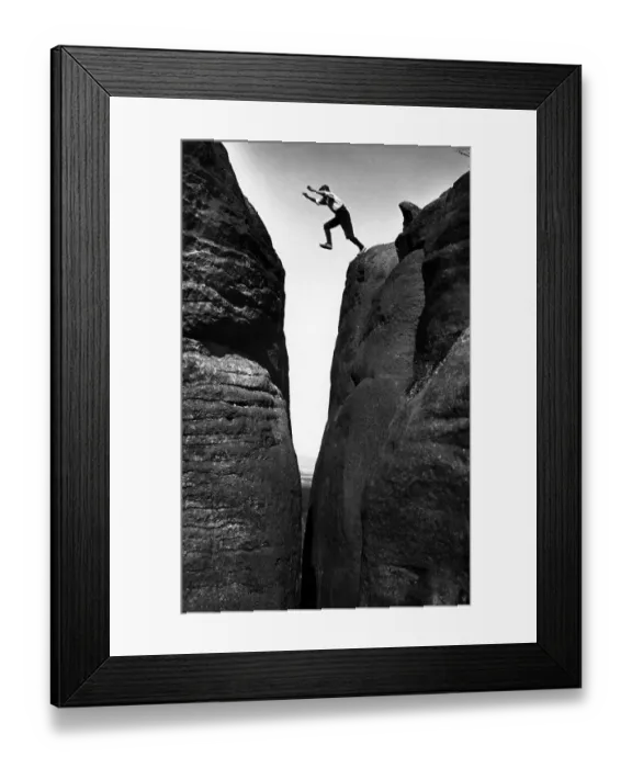 Framed Print : Man jumps over a crevice, historical photograph Framed Print : Man jumps over a crevice, historical photograph