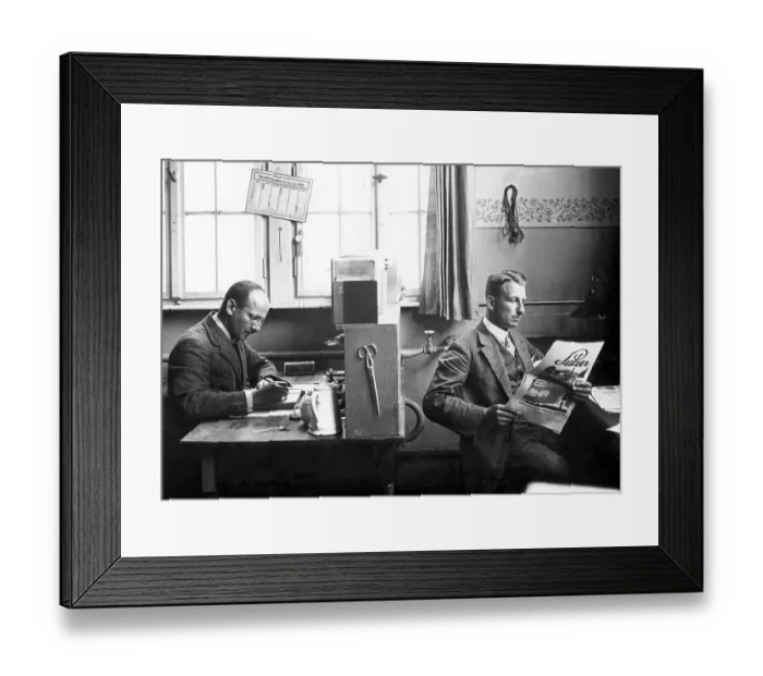 Framed Print : Two men in the office, one working Framed Print : Two men in the office, one working