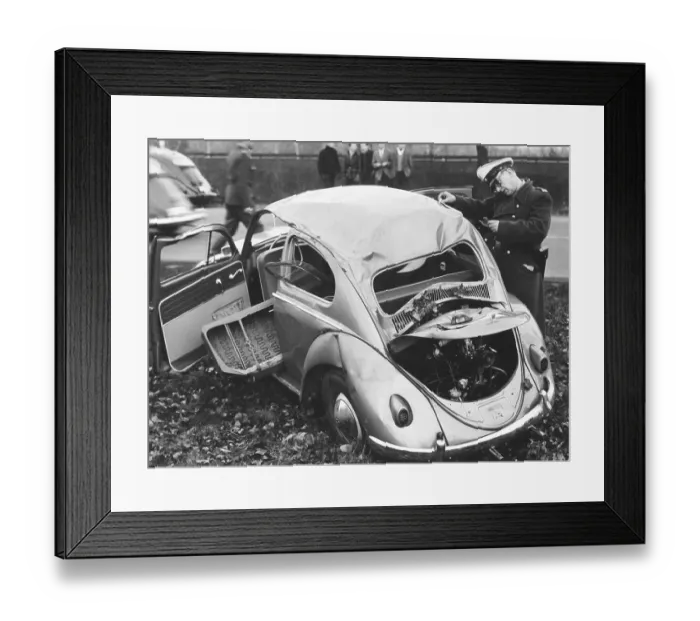 Framed Print : Police officer inspects VW beetle with total damage Framed Print : Police officer inspects VW beetle with total damage
