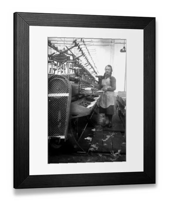 Framed Print : Textile industry, woman works in a spinning mill