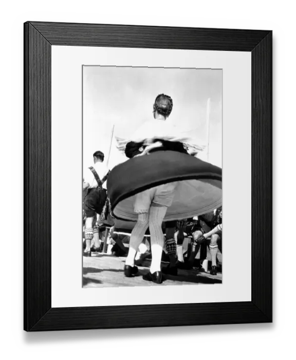 Framed Print : Dance in Bavarian traditional costume with view under the skirt Framed Print : Dance in Bavarian traditional costume with view under the skirt