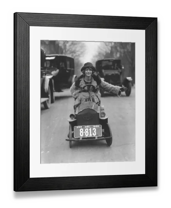 Framed Print : Woman driving in a soapbox on a busy street Framed Print : Woman driving in a soapbox on a busy street