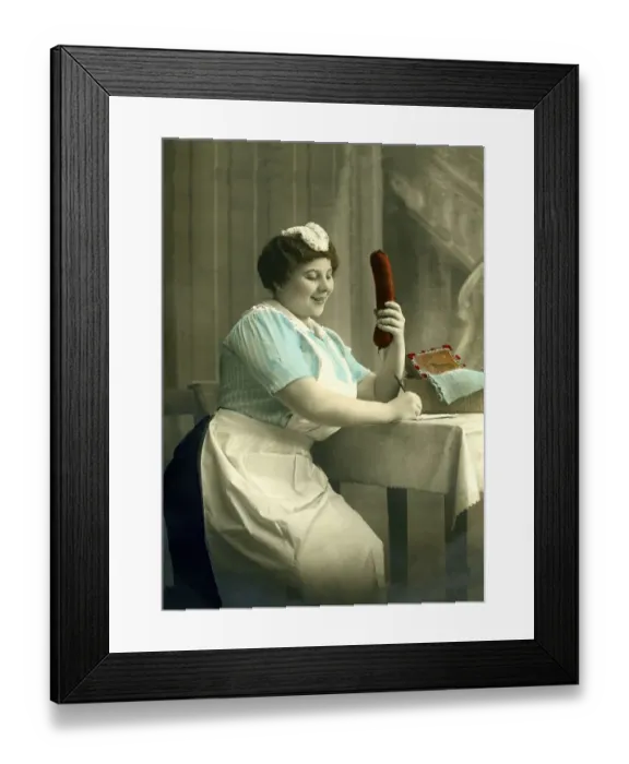 Framed Print : Housekeeper writes a letter with a big sausage in her hand