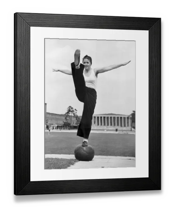Framed Print : Sport, woman balancing on a medicine ball Framed Print : Sport, woman balancing on a medicine ball