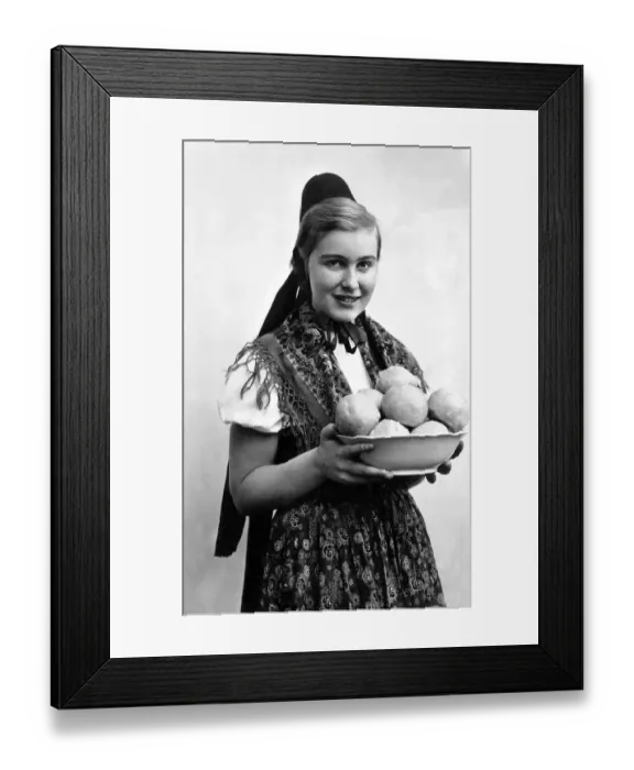 Framed Print : Woman in traditional traditional costume with dumplings Framed Print : Woman in traditional traditional costume with dumplings