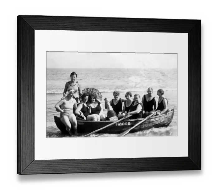 Framed Print : Vacation, nine women in swimsuit and with big champagne bottle on the beach in a rowing boat