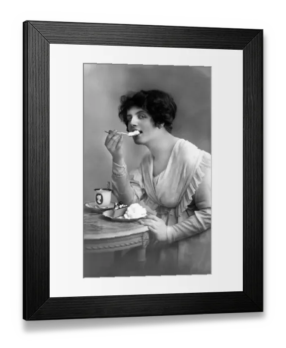 Framed Print : Woman eating cake with cream, 1910s