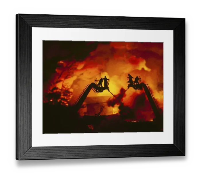 Framed Print : Firefighters extinguish a fire