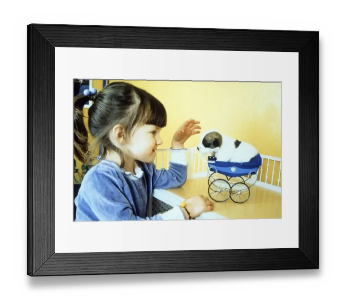 Framed Print : Girl playing with little puppy