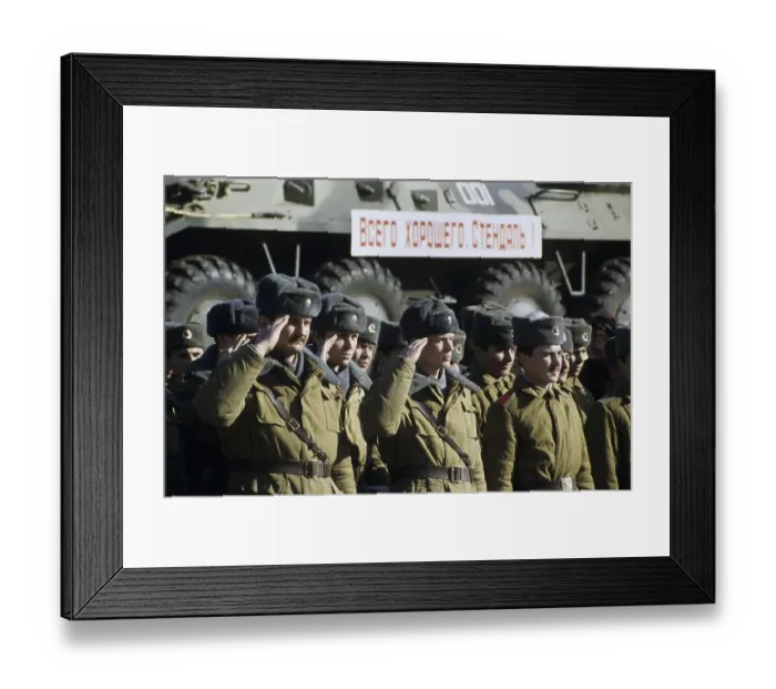 Framed Print : Russian soldiers saluting in front of a train transporting armoured vehicles during the withdrawal of Soviet troops