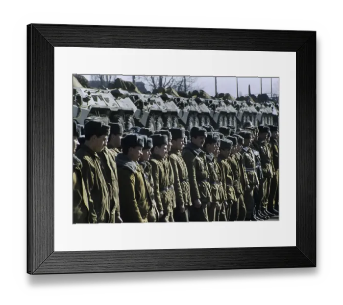 Framed Print : Russian soldiers standing in front a train transporting armoured vehicles during the withdrawal of Soviet troops