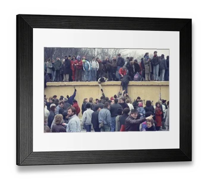 Framed Print : People climbing the Berlin Wall at Brandenburg Gate