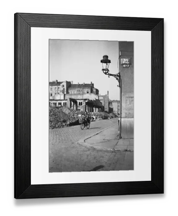 Framed Print : Woman on a bicycle riding through ruins