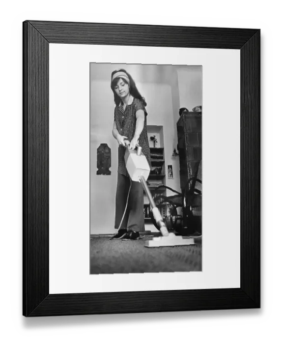 Framed Print : Young woman vacuuming, East Germany Framed Print : Young woman vacuuming, East Germany
