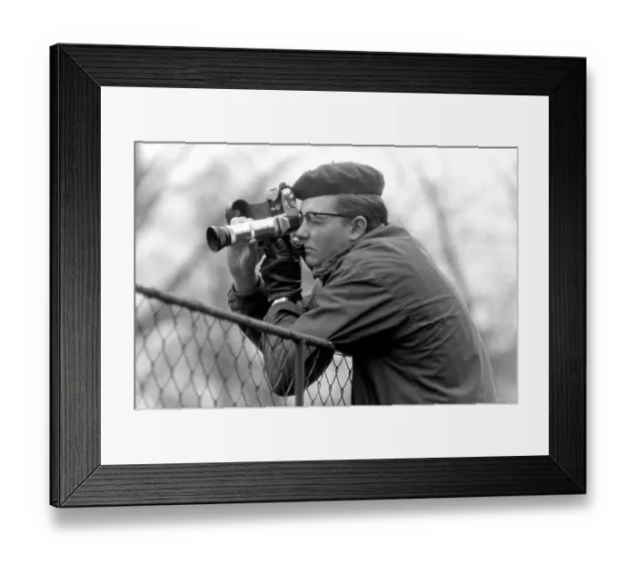 Framed Print : Young man taking pictures with a camera Framed Print : Young man taking pictures with a camera