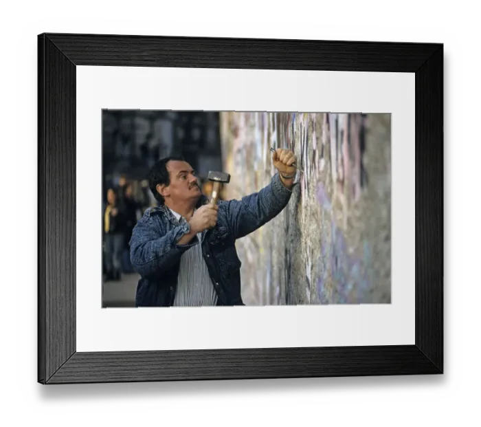 Framed Print : Fall of the Berlin Wall: man chiselling pieces off the Wall (Mauerspecht) Framed Print : Fall of the Berlin Wall: man chiselling pieces off the Wall (Mauerspecht)