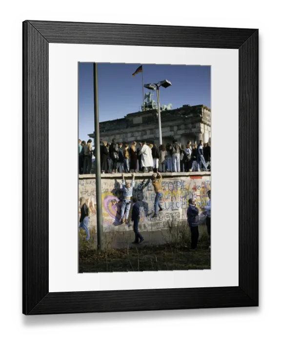Framed Print : Fall of the Berlin Wall: people from East and West Berlin climbing on the Wall at the Brandenburg Gate