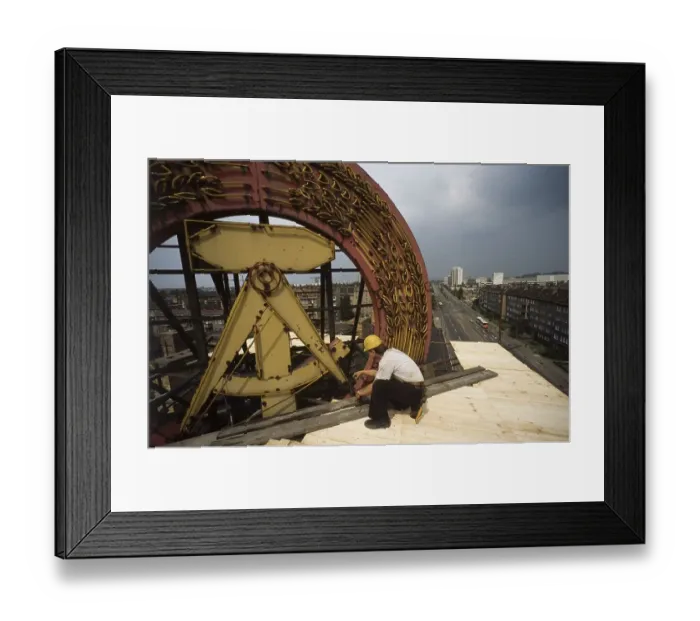 Framed Print : Fall of the Berlin Wall, construction workers removing a GDR symbol in East Berlin Framed Print : Fall of the Berlin Wall, construction workers removing a GDR symbol in East Berlin