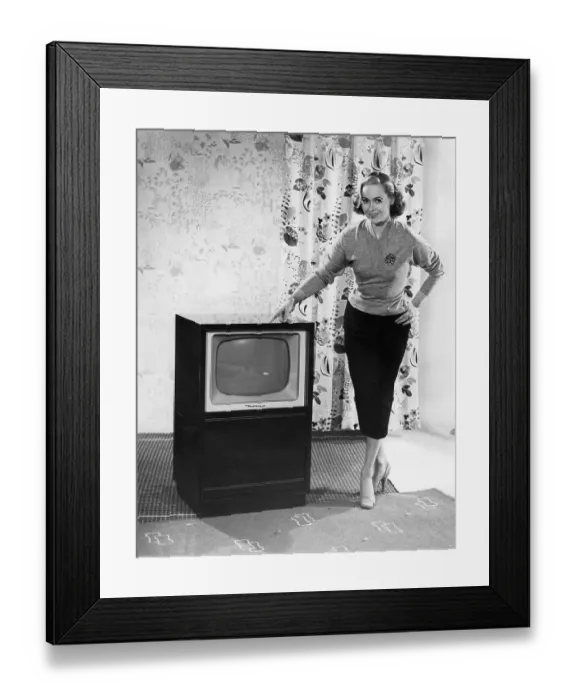 Framed Print : Woman posing next to a television