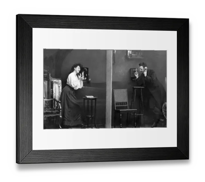 Framed Print : Man and woman telephoning, historical photo