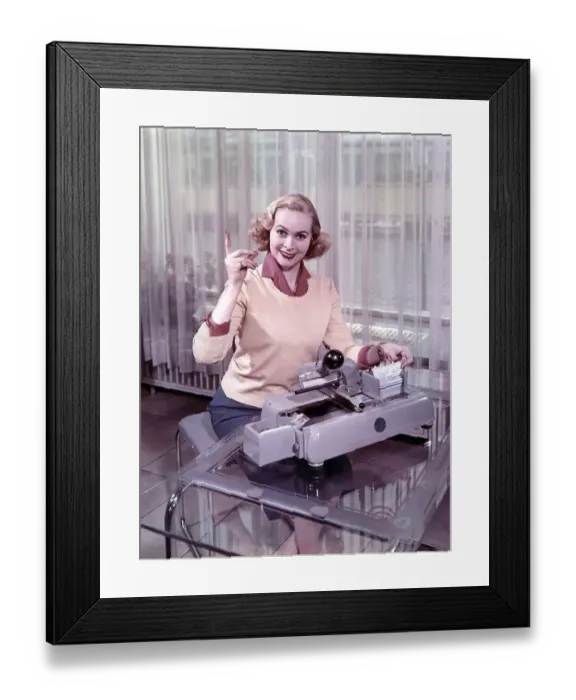 Framed Print : Woman sitting in front of a typewriter